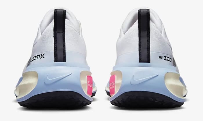 Rear view of white and blue Nike shoes.